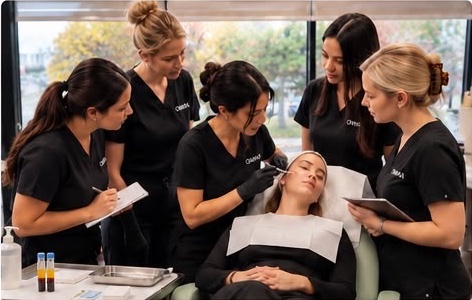 Medical aesthetics students practicing with a live model